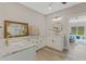 Bathroom boasts double sinks with granite counters, stylish vanity, and modern fixtures at 72 Fairway Cir, Umatilla, FL 32784
