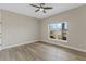 Bright bedroom features a ceiling fan, light gray walls, and durable wood-look floors at 72 Fairway Cir, Umatilla, FL 32784