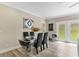 Bright dining room features modern table with clear chairs and lots of natural light at 72 Fairway Cir, Umatilla, FL 32784