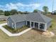 A newly built single-Gathering home with a covered porch and manicured landscaping at 72 Fairway Cir, Umatilla, FL 32784