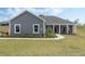 Charming single-story home with a well-manicured lawn and inviting front porch at 72 Fairway Cir, Umatilla, FL 32784