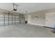Spacious garage with neutral color walls, an insulated garage door, and multiple access doors at 72 Fairway Cir, Umatilla, FL 32784