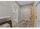 Hallway with glass shower, laundry closet and access door to backyard or garage at 72 Fairway Cir, Umatilla, FL 32784