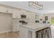 Spacious kitchen features stainless steel appliances, granite countertops, and breakfast bar at 72 Fairway Cir, Umatilla, FL 32784