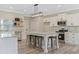 Spacious modern kitchen with stainless steel appliances and island with bar stool seating at 72 Fairway Cir, Umatilla, FL 32784