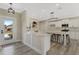 Modern kitchen with white cabinetry, granite countertops, and an island with bar stool seating at 72 Fairway Cir, Umatilla, FL 32784