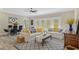Bright living area featuring hardwood floors, modern decor, and ample natural light at 72 Fairway Cir, Umatilla, FL 32784