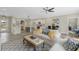 Open-concept living area with stylish furnishings, hardwood floors, and an adjacent kitchen at 72 Fairway Cir, Umatilla, FL 32784