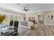 Living room features ceiling fan, access to backyard, and a couch with stylish throw pillows at 72 Fairway Cir, Umatilla, FL 32784