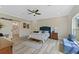 Bright main bedroom features a ceiling fan, walk-in closet and ensuite bathroom at 72 Fairway Cir, Umatilla, FL 32784