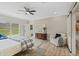 Bright and airy main bedroom boasts a ceiling fan and lots of natural light at 72 Fairway Cir, Umatilla, FL 32784
