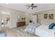 Spacious main bedroom with ceiling fan includes a view into the main bath at 72 Fairway Cir, Umatilla, FL 32784