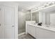 Modern bathroom with a glass shower enclosure and a double sink vanity at 734 Longboat Dr, Davenport, FL 33896