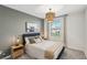 Cozy bedroom featuring a stylish pendant light, soft decor, and a large window at 734 Longboat Dr, Davenport, FL 33896