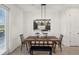Stylish dining area featuring modern decor, a wooden table, and bright, natural light at 734 Longboat Dr, Davenport, FL 33896