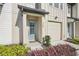 Inviting front entrance with a light blue door, complemented by colorful landscaping at 734 Longboat Dr, Davenport, FL 33896