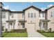 Charming townhome showcasing a well-manicured lawn and an attached single-car garage at 734 Longboat Dr, Davenport, FL 33896