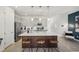 Open-concept kitchen with a large island, stainless steel appliances and modern lighting at 734 Longboat Dr, Davenport, FL 33896
