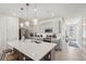 Spacious kitchen showcasing a large island, stainless steel appliances and stylish pendant lights at 734 Longboat Dr, Davenport, FL 33896
