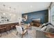 Open living space with a modern sofa and kitchen island with barstool seating at 734 Longboat Dr, Davenport, FL 33896