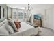 Bright main bedroom features large windows, sleek lighting, and modern decor at 734 Longboat Dr, Davenport, FL 33896