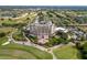 Aerial view of grand resort, showcasing immaculate landscaping, golf course, and parking at 7509 Mourning Dove Cir # 203, Reunion, FL 34747