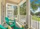 Inviting balcony features turquoise Adirondack chairs and serene views of the community at 7509 Mourning Dove Cir # 203, Reunion, FL 34747