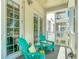 Outdoor balcony featuring two comfortable chairs and views of the community at 7509 Mourning Dove Cir # 203, Reunion, FL 34747