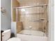 Bathroom featuring tiled walls, a bathtub and a sliding glass door at 7509 Mourning Dove Cir # 203, Reunion, FL 34747