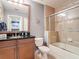 Bathroom with vanity, tub/shower combo, and neutral tile at 7509 Mourning Dove Cir # 203, Reunion, FL 34747