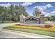 Well-maintained community entrance with manicured landscaping and decorative signage at 7509 Mourning Dove Cir # 203, Reunion, FL 34747