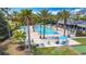 A beautiful community pool surrounded by palm trees offers residents relaxation and recreation at 7509 Mourning Dove Cir # 203, Reunion, FL 34747