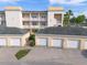 Exterior of apartment building featuring balconies and attached garages at 7509 Mourning Dove Cir # 203, Reunion, FL 34747