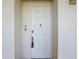 White front door with modern hardware and unit number 203 at 7509 Mourning Dove Cir # 203, Reunion, FL 34747