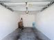 Clean, white-walled garage offering ample space, overhead lighting, and a secure parking area at 7509 Mourning Dove Cir # 203, Reunion, FL 34747