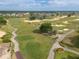 A scenic aerial view of the expansive golf course with lush fairways and water features at 7509 Mourning Dove Cir # 203, Reunion, FL 34747