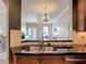 Kitchen and living room featuring granite counters, tile backsplash, and pendant lighting at 7509 Mourning Dove Cir # 203, Reunion, FL 34747