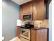 Gourmet kitchen equipped with stainless steel appliances and granite countertops at 7509 Mourning Dove Cir # 203, Reunion, FL 34747