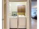Laundry closet with washer and dryer and custom cabinets for extra storage at 7509 Mourning Dove Cir # 203, Reunion, FL 34747