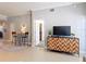 Living area featuring a small dining table, TV console, and an open door to the bathroom at 7509 Mourning Dove Cir # 203, Reunion, FL 34747