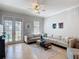 Bright living room with large sectional, tile flooring, and natural light at 7509 Mourning Dove Cir # 203, Reunion, FL 34747