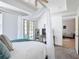 Spacious bedroom with a four-poster bed, with access to the patio via glass doors at 7509 Mourning Dove Cir # 203, Reunion, FL 34747