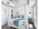 Bright bedroom with a canopy bed, lots of natural light, and modern décor at 7509 Mourning Dove Cir # 203, Reunion, FL 34747