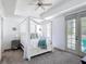 Bright main bedroom with white canopy bed, and glass doors to an outdoor balcony at 7509 Mourning Dove Cir # 203, Reunion, FL 34747