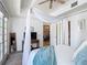 View of the main bedroom showing the canopy bed and open doors to the hall at 7509 Mourning Dove Cir # 203, Reunion, FL 34747