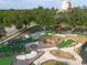 Aerial view of mini golf, featuring winding paths, water features, and lush landscaping at 7509 Mourning Dove Cir # 203, Reunion, FL 34747