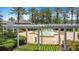 Scenic view of a community fountain, framed by a pergola and lush greenery at 7509 Mourning Dove Cir # 203, Reunion, FL 34747