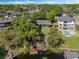 An aerial shows the home with lake access featuring a private dock and lush landscaping at 7540 Lake Marsha Dr, Orlando, FL 32819