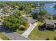 Aerial view of the property showcasing its proximity to a lake, swimming pool, lush greenery, and neighborhood at 7540 Lake Marsha Dr, Orlando, FL 32819