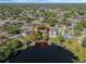 Lovely aerial showing waterfront home with mature landscaping and a private dock at 7540 Lake Marsha Dr, Orlando, FL 32819